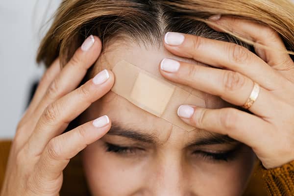 Woman with Facial Injuries on the Forehead | Serious Injuries Attorney | Berenson Injury Law